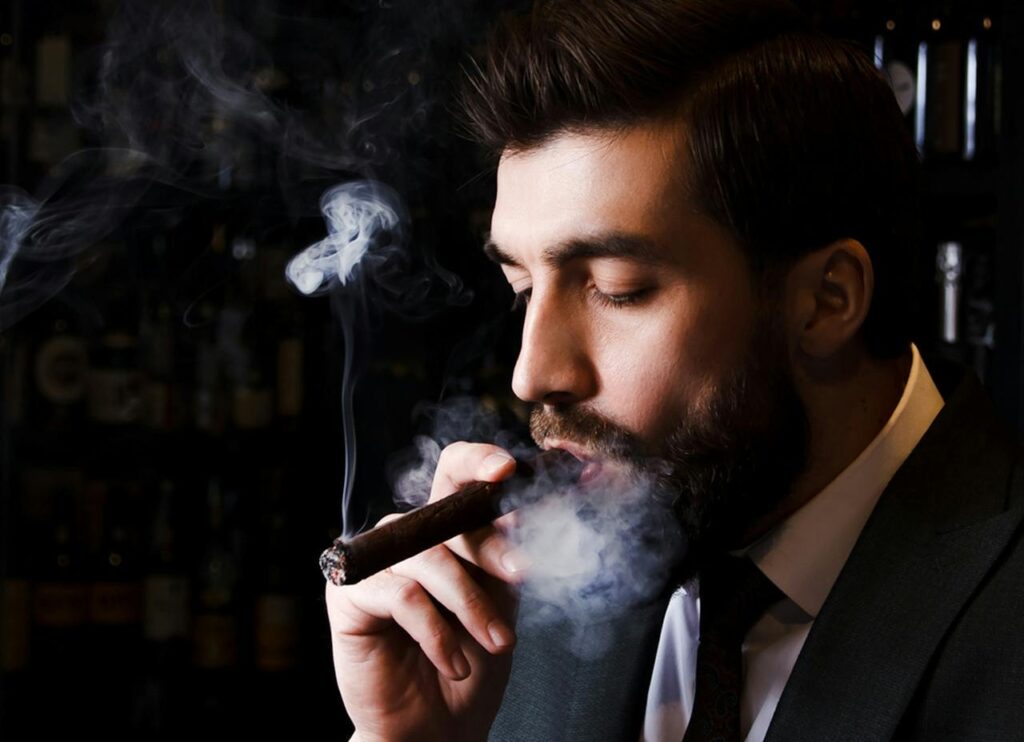 man in a suit smoking a cigar